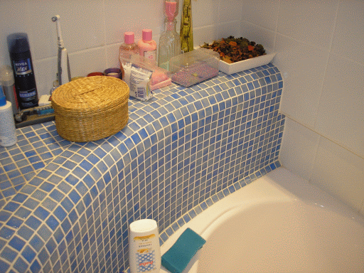 fürdőszoba részlet, lekerekített élű fal mozaikburkolattal.